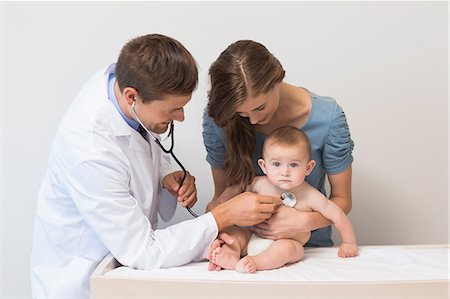 pictures of mum and baby in hospital - Handsome pediatrician checking baby boy held with his mother Stock Photo - Premium Royalty-Free, Code: 6109-07601340