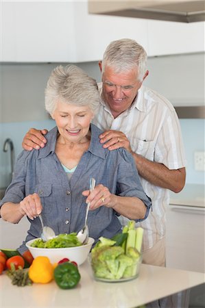 Happy senior couple preparing a salad Stock Photo - Premium Royalty-Free, Code: 6109-07601384