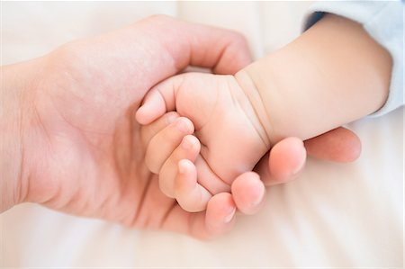 simsearch:6109-08390041,k - Mother holding baby sons hand Stock Photo - Premium Royalty-Free, Code: 6109-07601326