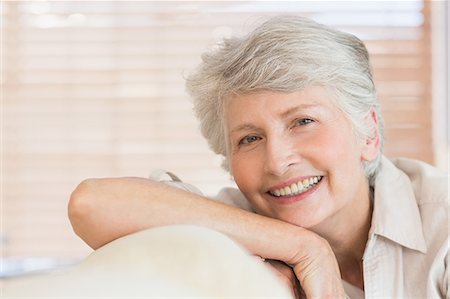 elderly portrait - Senior woman sitting on couch smiling at camera Stock Photo - Premium Royalty-Free, Code: 6109-07601451