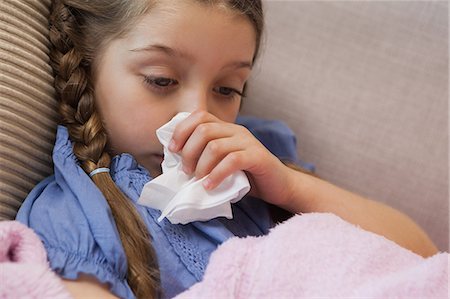 sickness - Young girl blowing nose with tissue paper Stock Photo - Premium Royalty-Free, Code: 6109-07601483