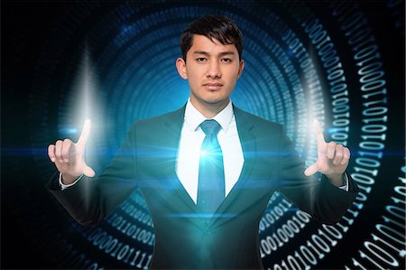 Serious businessman touching lights Stock Photo - Premium Royalty-Free, Code: 6109-07601590