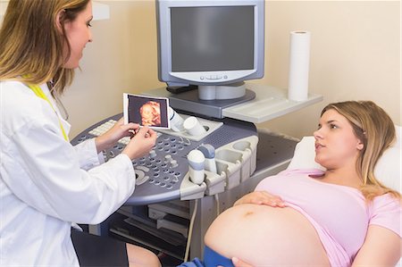 pregnant woman with doctor - Doctor showing picture to the pregnant woman Stock Photo - Premium Royalty-Free, Code: 6109-08203382