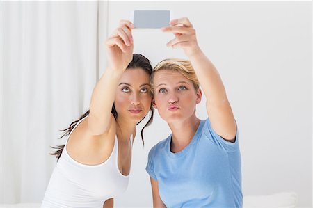 pouting (sexy look) - Smiling homosexual couple taking selfies Stock Photo - Premium Royalty-Free, Code: 6109-08203489