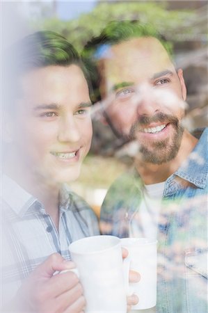 Happy homosexual couple looking through the windows Stock Photo - Premium Royalty-Free, Code: 6109-08203630