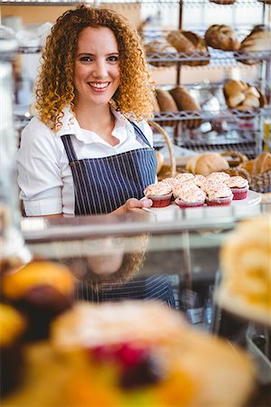 food and beverage service uniform - Pretty barista preparing plate with cupcakes Stock Photo - Premium Royalty-Free, Code: 6109-08203838