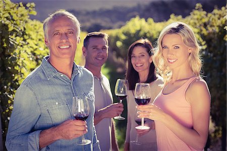 simsearch:6109-08204218,k - Portrait of smiling group standing next to grapevine Stock Photo - Premium Royalty-Free, Code: 6109-08204012