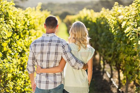 simsearch:6109-08204218,k - Rear view of embracing couple standing next to grapevine Stock Photo - Premium Royalty-Free, Code: 6109-08204017