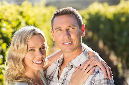 simsearch:6109-08204218,k - Portrait of smiling couple embracing next to grapevine Stock Photo - Premium Royalty-Free, Code: 6109-08204020