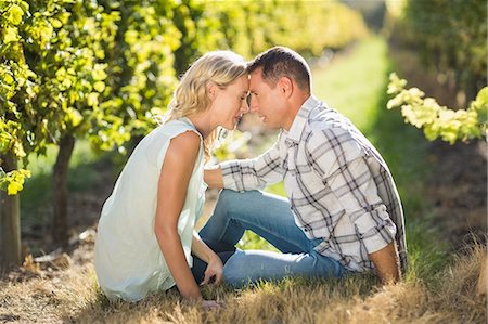 simsearch:6109-08204218,k - Couple sitting closely with eyes closed next to grapevine Stock Photo - Premium Royalty-Free, Code: 6109-08204025