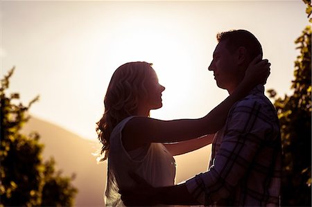 simsearch:6109-08204218,k - Couple embracing between grapevine Stock Photo - Premium Royalty-Free, Code: 6109-08204033