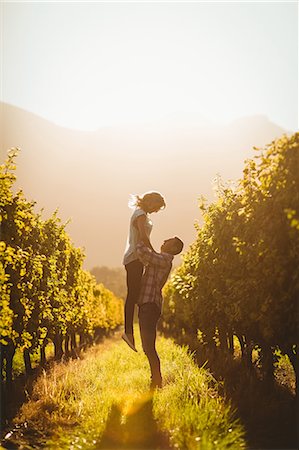 simsearch:6109-08204218,k - Man lifting his woman between grapevine Stock Photo - Premium Royalty-Free, Code: 6109-08204030