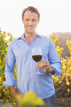 simsearch:6109-08204218,k - Smiling man with red wine glass Stock Photo - Premium Royalty-Free, Code: 6109-08204241