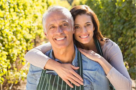 simsearch:6109-08204218,k - Embracing couple wearing aprons Stock Photo - Premium Royalty-Free, Code: 6109-08204332