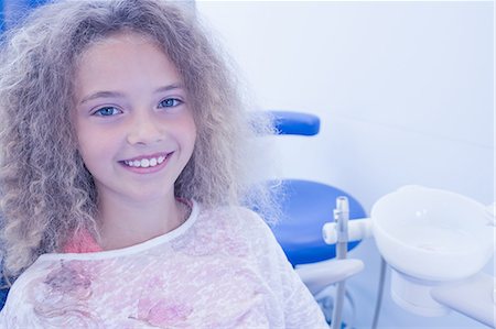 dental bib - Smiling young patient sitting in dentists chair Stock Photo - Premium Royalty-Free, Code: 6109-08389656
