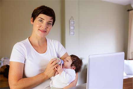 simsearch:6109-08390041,k - Smiling mother feeding her baby Stock Photo - Premium Royalty-Free, Code: 6109-08390040