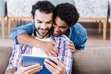 Happy gay couple using tablet Stock Photo - Premium Royalty-Free, Code: 6109-08390086