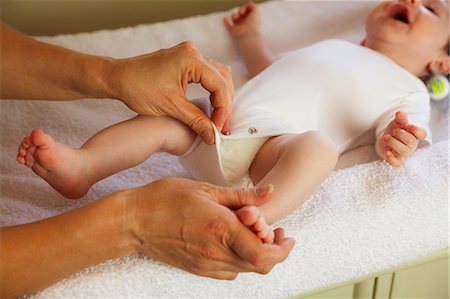 simsearch:6109-08390041,k - Newborn being getting dressed by the mother Stock Photo - Premium Royalty-Free, Code: 6109-08390003