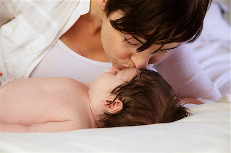 simsearch:6109-08390041,k - Mother kissing newborn Stock Photo - Premium Royalty-Free, Code: 6109-08390009