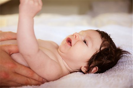 simsearch:6109-08390041,k - Smiling newborn on changing table Stock Photo - Premium Royalty-Free, Code: 6109-08390033