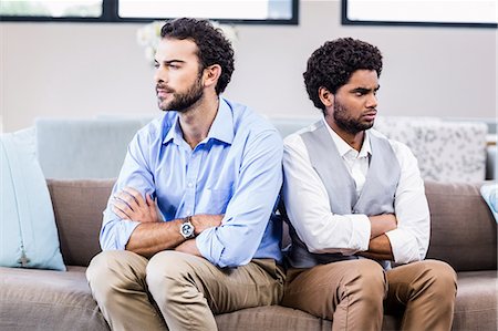 simsearch:6109-07601529,k - Gay couple sitting back-to-back after arguing Stock Photo - Premium Royalty-Free, Code: 6109-08390133