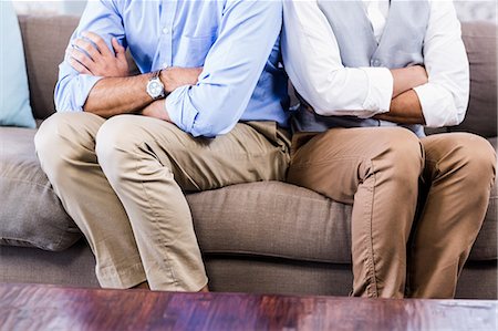 simsearch:6109-07601529,k - Gay couple sitting back-to-back after arguing Stock Photo - Premium Royalty-Free, Code: 6109-08390134