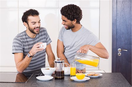 simsearch:6109-08390293,k - Happy gay couple having breakfast and talking Stock Photo - Premium Royalty-Free, Code: 6109-08390258