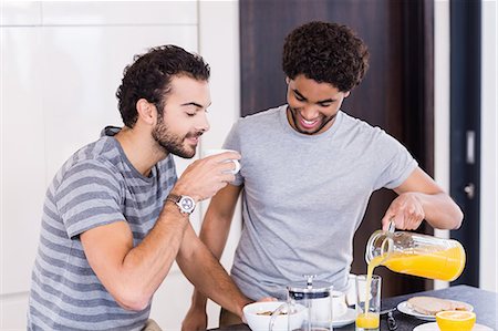 simsearch:6109-08390293,k - Happy gay couple having breakfast and talking Stock Photo - Premium Royalty-Free, Code: 6109-08390259