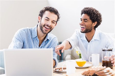 simsearch:6109-08390293,k - Happy gay couple having breakfast and using laptop Stock Photo - Premium Royalty-Free, Code: 6109-08390270