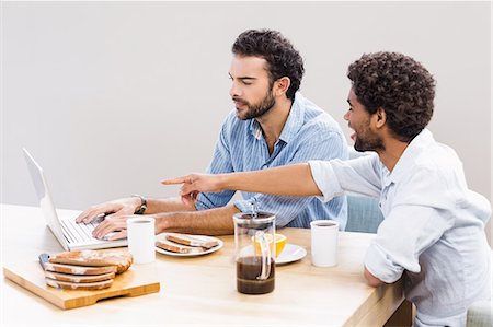 simsearch:6109-08390293,k - Happy gay couple having breakfast and using laptop Stock Photo - Premium Royalty-Free, Code: 6109-08390271