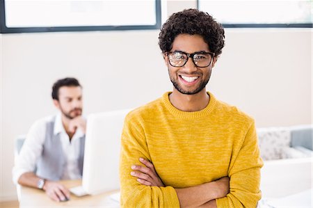 studio creative group - Portrait of smiling man with arms crossed Stock Photo - Premium Royalty-Free, Code: 6109-08390362