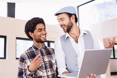 studio creative group - Happy gay couple using laptop Stock Photo - Premium Royalty-Free, Code: 6109-08390337