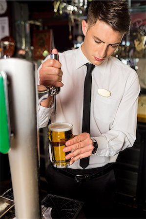 Well dressed bartender serving beer Stock Photo - Premium Royalty-Free, Code: 6109-08394901