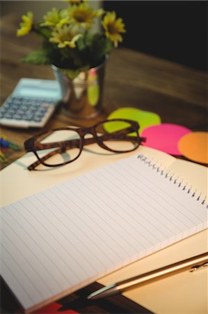 simsearch:6109-08395080,k - High angle view of notepads and eyeglasses on desk Stock Photo - Premium Royalty-Free, Code: 6109-08395089