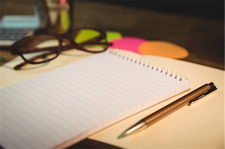 person organizing desk - High angle view of notepad and pen on desk Stock Photo - Premium Royalty-Free, Code: 6109-08395090