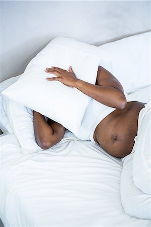 pregnant black belly - Pregnant woman with pillow on her head Stock Photo - Premium Royalty-Free, Code: 6109-08395299