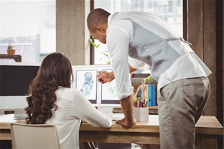 people working inside office - Man and woman discussing on design Stock Photo - Premium Royalty-Free, Code: 6109-08395512