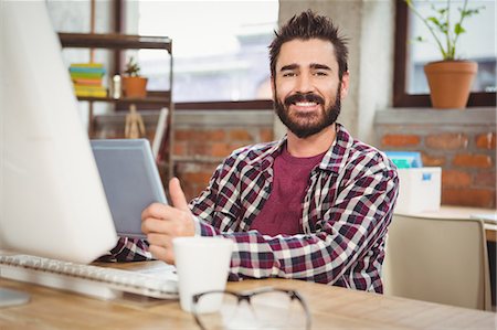 Happy businessman holding digital tablet Stock Photo - Premium Royalty-Free, Code: 6109-08395765