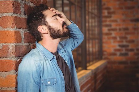 Stressed man hand on forehead Stock Photo - Premium Royalty-Free, Code: 6109-08395796