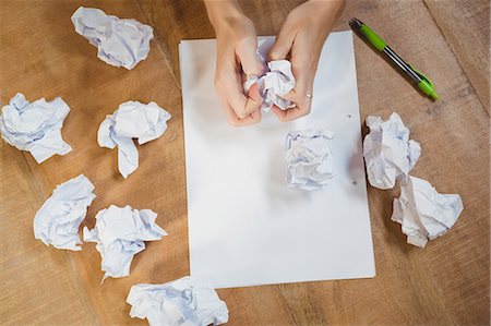 simsearch:6109-08395080,k - Woman crumpling paper on office desk Stock Photo - Premium Royalty-Free, Code: 6109-08395739