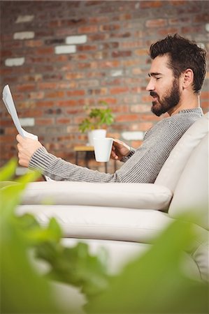 Side view of man reading papers Stock Photo - Premium Royalty-Free, Code: 6109-08395852