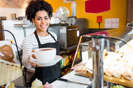 staff (female) - Waitress serving cappuccino to camera Stock Photo - Premium Royalty-Free, Code: 6109-08395949