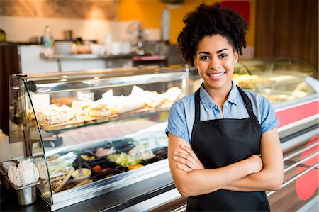 Pretty waitress smiling at camera Stock Photo - Premium Royalty-Free, Code: 6109-08395929