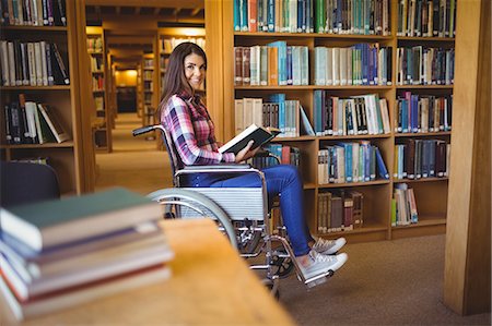 Portrait of disabled female student with book Stock Photo - Premium Royalty-Free, Code: 6109-08396277