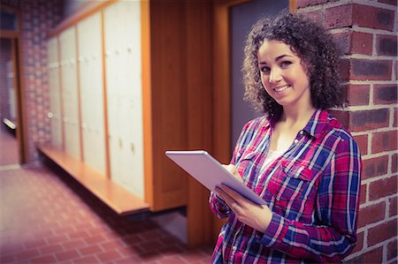 Pretty student using her tablet pc Stock Photo - Premium Royalty-Free, Code: 6109-08396343