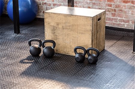 Image of four kettlebells and a box Stock Photo - Premium Royalty-Free, Code: 6109-08396844