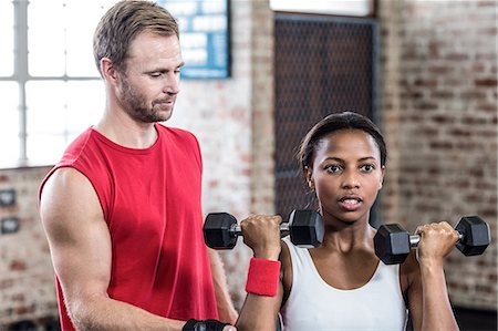 simsearch:689-03131217,k - Smiling couple exercising with dumbbells Stock Photo - Premium Royalty-Free, Code: 6109-08396860