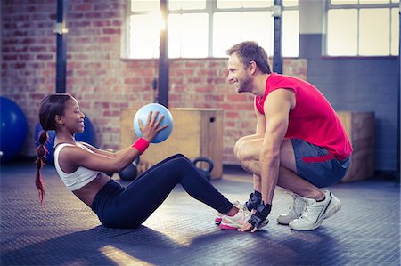 exercising with friend - Muscular couple doing abdominal ball exercise Stock Photo - Premium Royalty-Free, Code: 6109-08396825