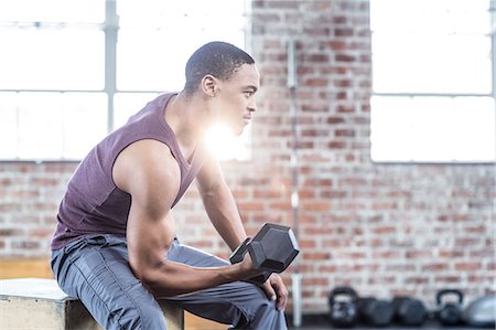 Serious muscular man lifting dumbbell Stock Photo - Premium Royalty-Free, Code: 6109-08396985