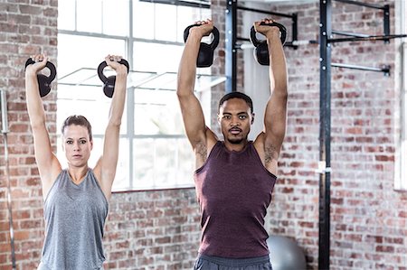 simsearch:689-03131217,k - Fit couple lifting kettle bells Stock Photo - Premium Royalty-Free, Code: 6109-08396993